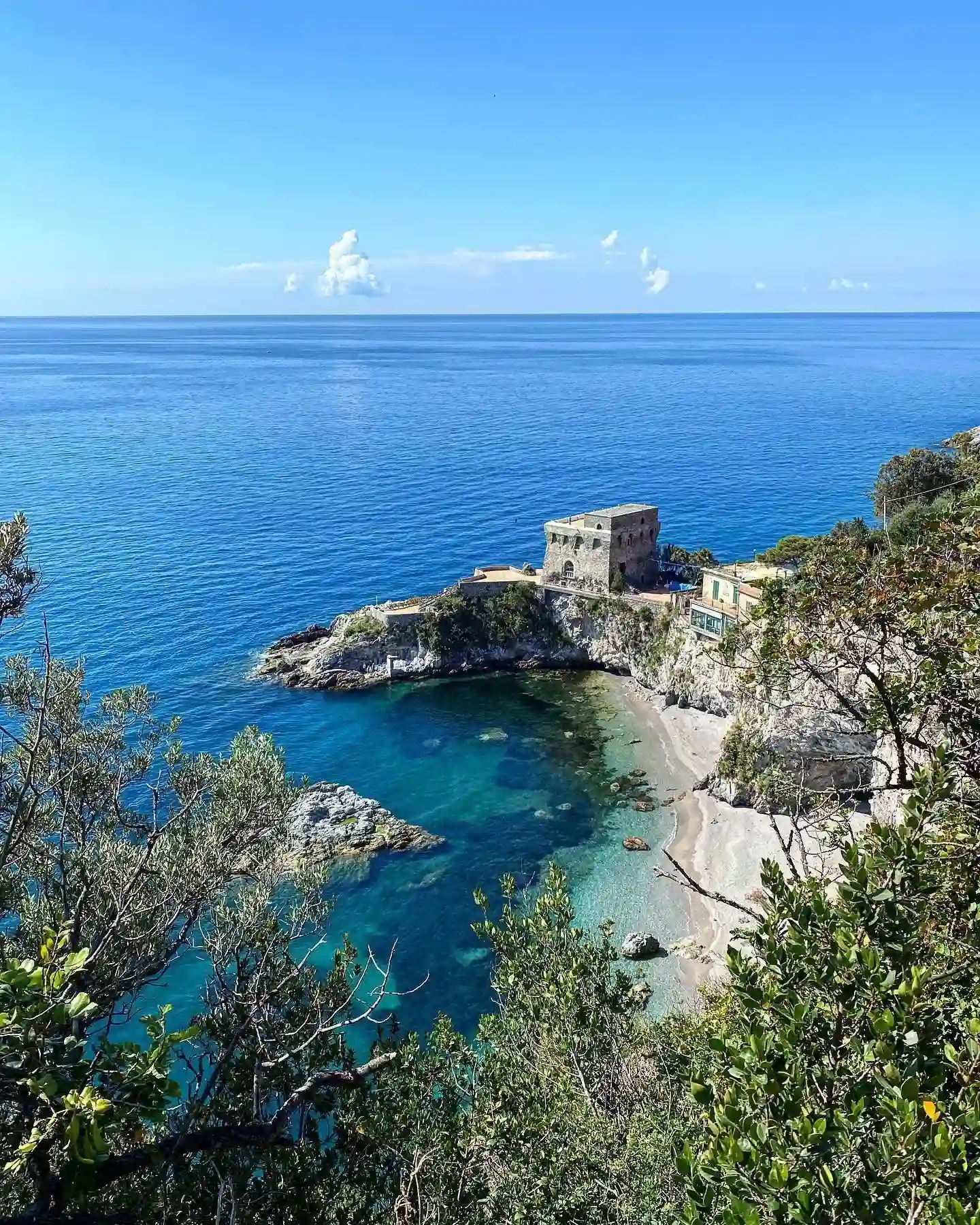 Erchie beach on the Amalfi Coast with the coastal tower and blue sea